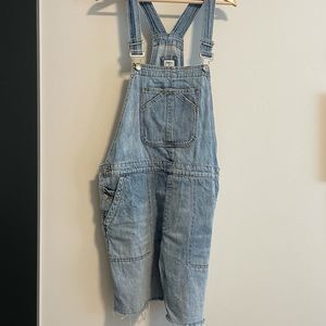 Light denim short overalls with raw hem.